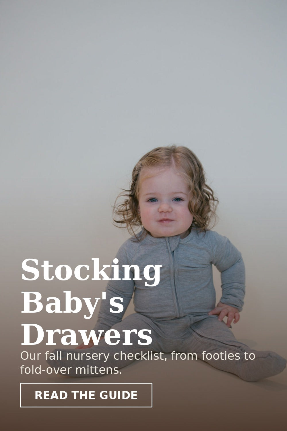 Toddler sitting in a heather gray bamboo pajama set